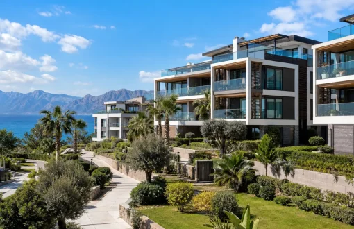 Apartments for sale in Antalya. Modern residential buildings near the Mediterranean coast with mountain views.